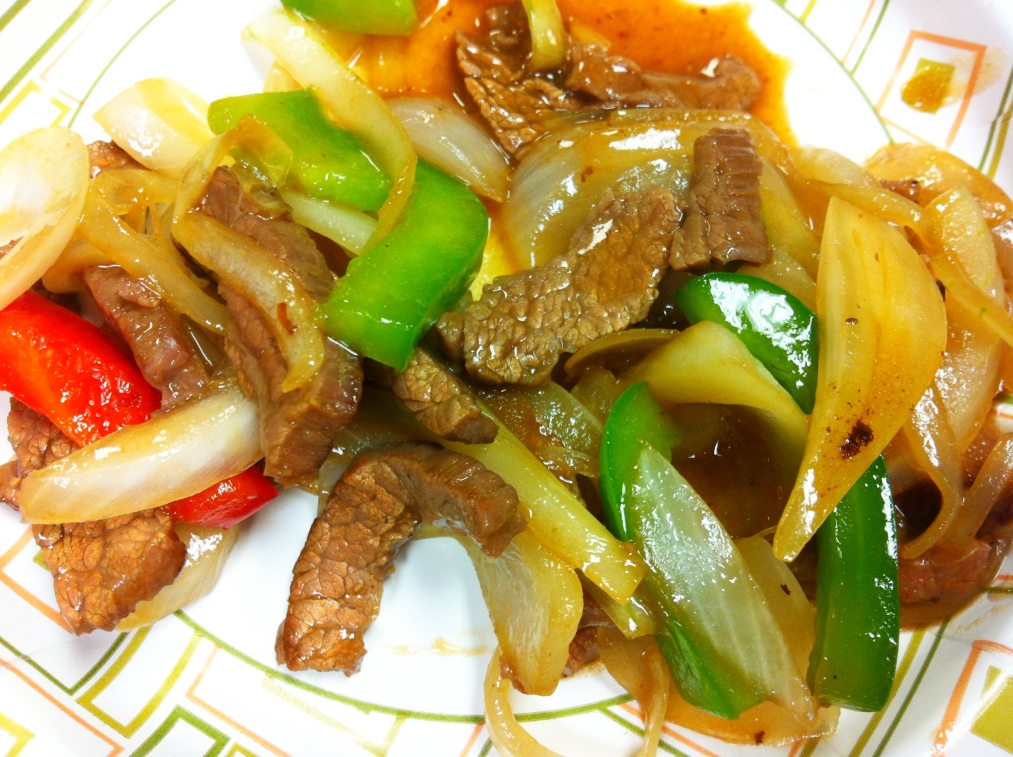 Beef, bell peppers of multiple hues, and onions